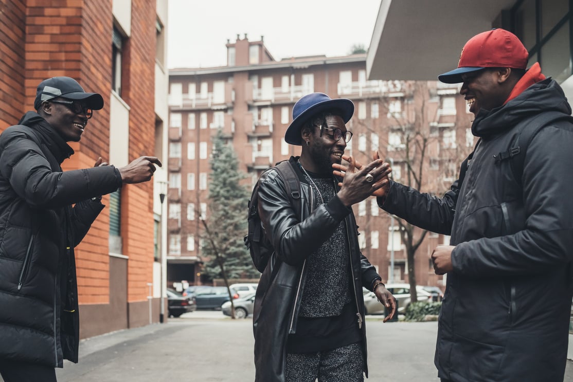 Three Men Greeting in the Street